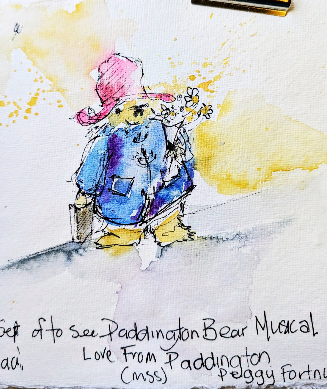 Watercolour sketch of Paddington Bear in blue duffle coat and red hat, painted by Sheila Gill